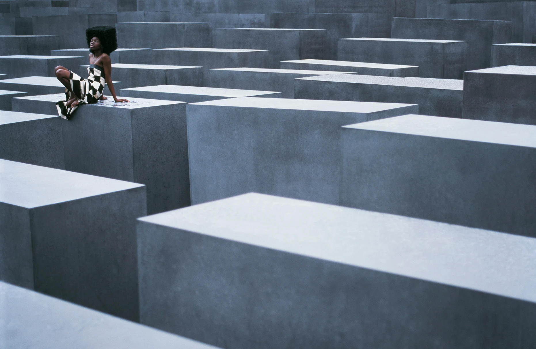 künstlerische Darstellung des Holocaust-Mahnmal, menschenleer, nur ein model posiert in ausgefallener Kleidung